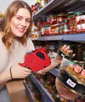 Woman using Super Durable 1121 Piece Retail Price Tag Gun Haul with red label tool to tagcan in supermarket aisle.