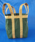 Rock Solid Heavy Duty Crane Lifting Bag Anti Tear Reusable Cargo Net Built Tough For Serious Job Sites And Relentless Heavy Hauling Across Any Terrain, green canvas bag with straps.