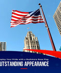 Heavy Duty 3x5 Outdoor American Flag Made In USA With Embroidered Stars And Sewn Stripes waving atop a pole against cityscape
