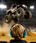 Child wearing Kids Ear Protection 2 Pack Noise Canceling Headphones For Concerts And Loud Events Durable Cushioned Earpads at monster truck show.