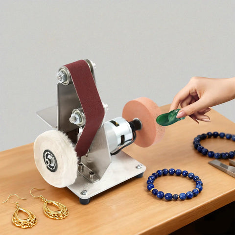 Rock Solid 7 Speed Mini Belt Sander Featuring Ultra Quiet Performance And 20 Tough Sanding Belts For Precision Woodworking Glass Etching And Detailed Jewelry Grinding On Any Weekend Warrior Build Back At The Local Shop in use on a table with jewelry items.