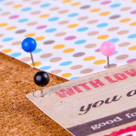 Kickass Bulk Supply Of 600 Heavy Duty Map Tack Push Pins Featuring Smooth Plastic Bead Heads And Vibrant Assorted Colors For Bulletin Boards And Classroom Organization with blue, pink, and black pins on corkboard
