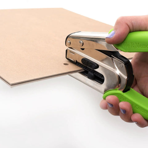 Crop-A-Dile Power Punch for one quarter inch holes scrapbooking tool in use, punching through thick chipboard with green handles