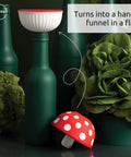Cool Mushroom Shaped Silicone Funnel Foldable Kitchen Tool on green bottles with plants in background