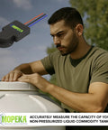 Man installing Pro200 Ultrasonic Tank Level Sensor with Bluetooth and wired connectivity on non-pressurized tank outdoors.