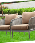 Outdoor seating with brown cushions and silver frames in a garden setting, secured with 24 Pack Outdoor Furniture Clips For Sectional Sofas And Wicker Chairs.