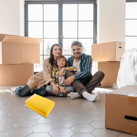 Family sitting on floor with boxes and yellow bubble mailers. Waterproof Bubble Mailers 25 Pack 28x37 cm Plus 6 cm Thick Self Adhesive Padded Envelopes displayed.