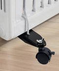Black metal Tceapoo mobile pulley bracket attached to oil-filled radiator; features 360° swivel caster wheel and brake.