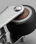 Smooth Operator Vertical Track Roller For Heavy Duty Sliding Barn Doors With Rock Solid Anti Sag Bracket And Quiet Double Bearing Rubber Bottom Wheels Upgrade Kit close-up view of roller wheel and metal bracket.