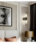 Modern Black Wall Sconces Bring A Smooth Chill Vibe With Classic Glass Shades Perfect For Bedroom Bedside Living Room Or Hallway Decor Glare Free Minimalist Indoor Lighting Solid Build Zero Hassle Setup, mounted beside a bed with stylish decor.
