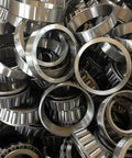 Two Pack Tapered Roller Bearings LM11749 LM11710 17.462mm bore visible in a pile, showcasing robust 52100 GCr15 bearing steel construction.