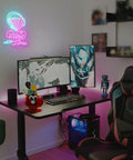 Gaming setup with "Game Zone" neon sign, multi-monitor desk, gaming chair, and accessories.
