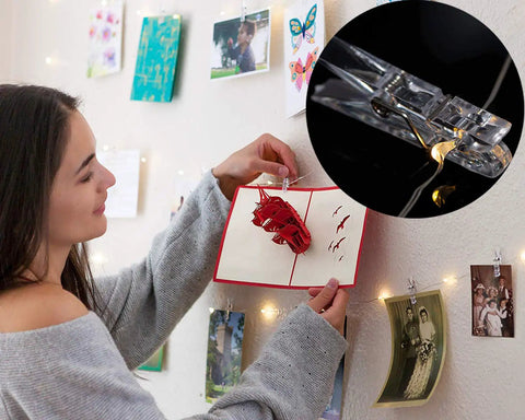 Cozy 17 Foot Fairy String Lights With 50 LEDs And Clear Clips For Dorm Rooms Bedroom Decor And Weddings hung on a wall.