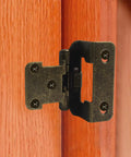 Four Pack Half Inch Overlay Cabinet Hinges With Full Hardware Antique Brass Finish shown on a wooden cabinet door.