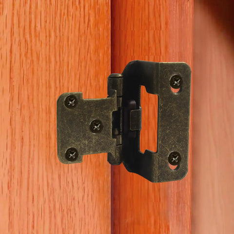 Four Pack Half Inch Overlay Cabinet Hinges With Full Hardware Antique Brass Finish shown on a wooden cabinet door.