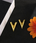 Chunky Gold Plated Earrings for Women, 18K Gold Plated Stainless Steel V Shape Heart Shell Studs on black surface.
