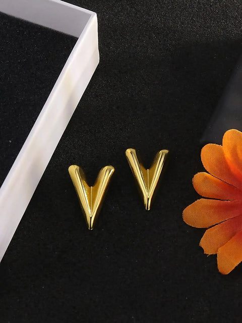 Chunky Gold Plated Earrings for Women, 18K Gold Plated Stainless Steel V Shape Heart Shell Studs on black surface.