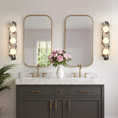 Natural Marble Bathroom Vanity Light, Alabaster 3-Light Wall Sconce next to mirrors in elegant bathroom setup with flowers.