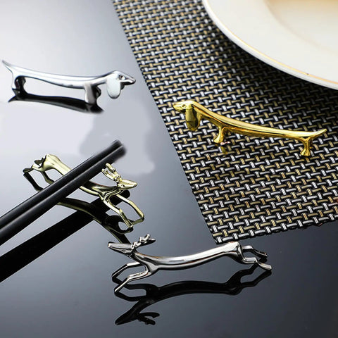 Stainless Steel Cutlery Holder Rack with gold-toned animal design on a black reflective surface, modern tableware display