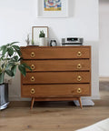 Dresser with Beefy 4 Pack 2-1/2 Inch Solid Cupboard Knobs Zinc Alloy Vintage Ring Cabinet Pulls Gold installed in a room with plants.