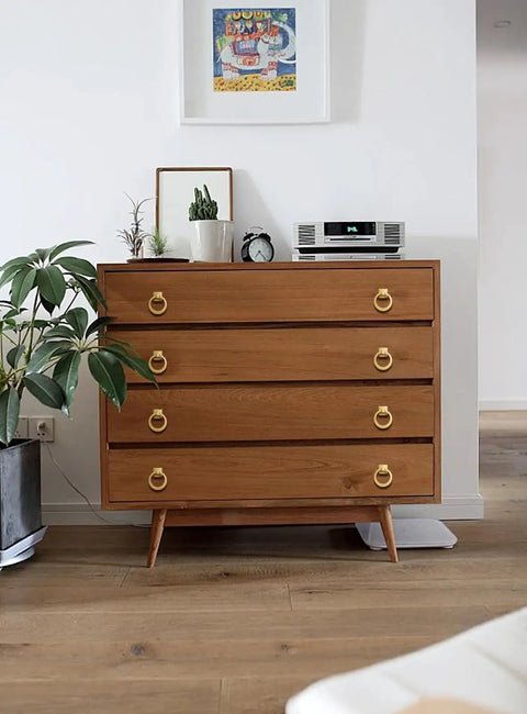 Dresser with Beefy 4 Pack 2-1/2 Inch Solid Cupboard Knobs Zinc Alloy Vintage Ring Cabinet Pulls Gold installed in a room with plants.