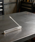 Pro Grade High Speed Steel Tire Valve Threading Tap For 5V1-36 Threads, in plastic case on workbench, silver metal tool