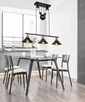 Three Light Pulley Pendant Island Light With Industrial Vintage Rustic Vibe hung over dining table in kitchen