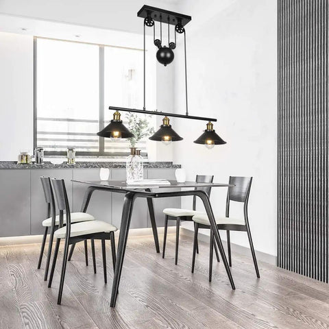 Three Light Pulley Pendant Island Light With Industrial Vintage Rustic Vibe hung over dining table in kitchen