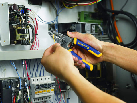 Person using Wire Stripper And Cutter 6 Inch With ProTouch Grips And Spring Assist Jaw for electrical wiring inside panel