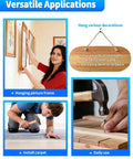 Woman hanging picture frame using Heavy Duty Black Upholstery Tacks 1 Inch Bulk Furniture Hardware For Fast Home Repairs Strong Steel Pins.