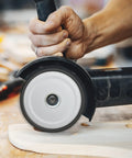 Heavy Duty Four Pack Of 4-1/2 Inch Wood Carving Discs With 7/8 Inch Arbor in use on wood surface with angle grinder.