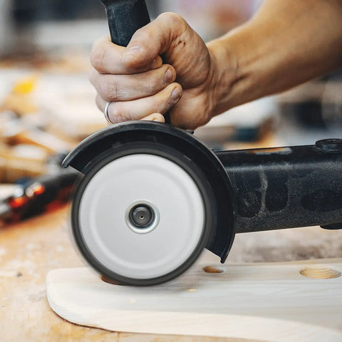Heavy Duty Four Pack Of 4-1/2 Inch Wood Carving Discs With 7/8 Inch Arbor in use on wood surface with angle grinder.