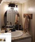 Bathroom with Industrial Two Light Black Wall Sconce with Clear Glass Shade over vanity mirror
