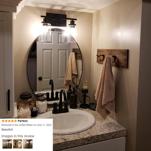 Bathroom with Industrial Two Light Black Wall Sconce with Clear Glass Shade over vanity mirror