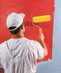Textured Sponge Paint Roller For Wall Painting With Ergonomic Handle in use on a red wall for efficient coating.