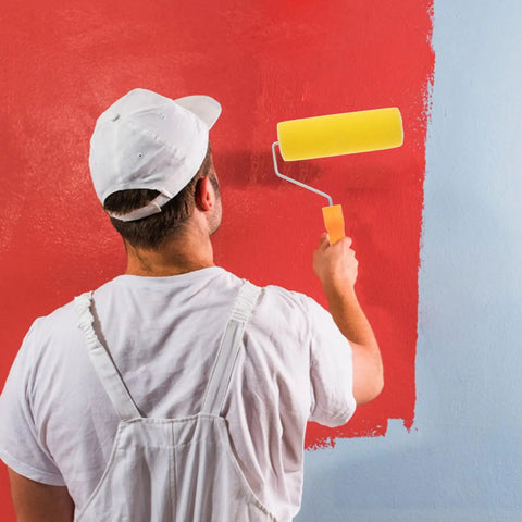 Textured Sponge Paint Roller For Wall Painting With Ergonomic Handle in use on a red wall for efficient coating.