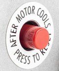 Red reset button labeled 'Press to Reset' on a heavy duty electric motor. Important for operation after cooling.