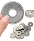 Close-up of a stainless steel Fender washer (1/2 in hole, 2 in OD) held by fingers with a pile of washers nearby.