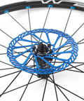 MTB Disc Brake Rotors Set 160mm 180mm 203mm 2 Pieces With 12 Screws Stainless Steel 2mm Thick 44mm Bolt Circle Blue Finish For Mountain Bikes Built For Dope Trail Riders shown mounted on a bike wheel
