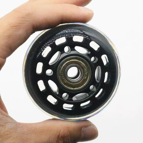 Hand holding 64mm Inline Skate Wheels 82A Polyurethane With ABEC-7 Bearings, showcasing central bearing detail.