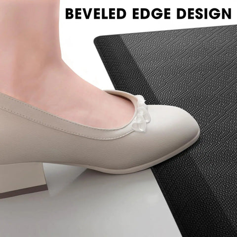 Woman's foot in shoe on beveled edge of Comfy Cushioned Anti Fatigue Kitchen Mat For Standing Long Shifts Water Resistant Non Slip Floor Rug Desk Mat Perfect For Kitchen Sink Office Laundry 17.3 By 28 Inches