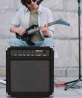 Musician with guitar and 30W Bass Amp With Retractable Handle For Home Practice And Gig Ready Stage Performance