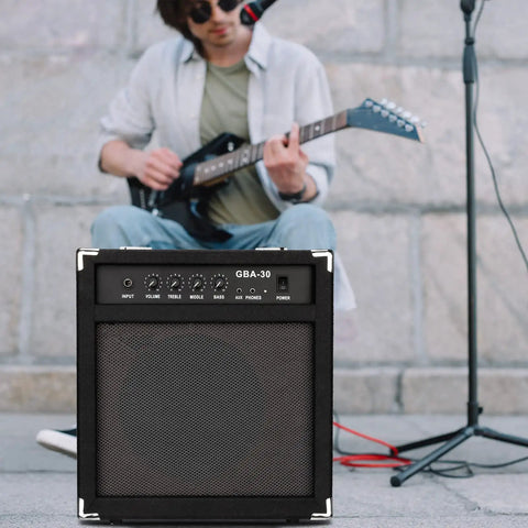 Musician with guitar and 30W Bass Amp With Retractable Handle For Home Practice And Gig Ready Stage Performance
