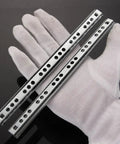 Solid Side Mount Ball Bearing Drawer Slides Two Pack Heavy Gauge Steel Cabinet Runners With Slick Silent Bearings shown in glove.
