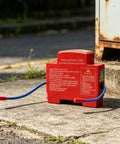 Heat Trip Automatic Fire Suppressor For Truck Engine Compartment Featuring Slick Snap On Install And Heavy Duty 360 Degree Coverage on pavement.