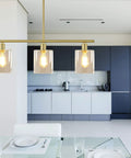 Rustic Industrial 3 Light Pendant Chandelier With Clear Glass Shades In Gold Finish above modern kitchen island