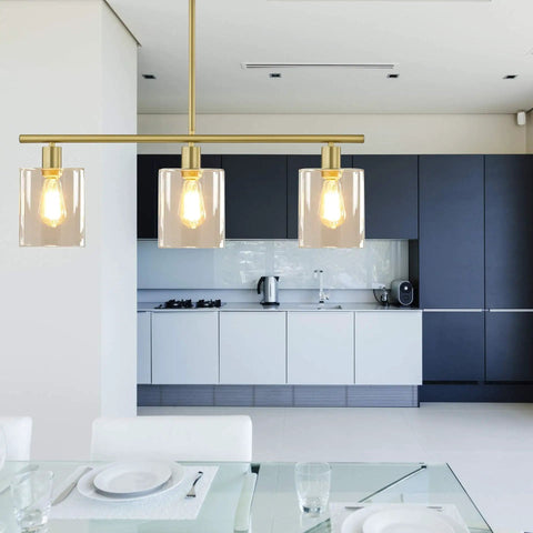 Rustic Industrial 3 Light Pendant Chandelier With Clear Glass Shades In Gold Finish above modern kitchen island