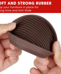 Close-up of brown rubber caster cup being flexed, showcasing durable material for Heavy Duty Rubber Furniture Floor Protectors 2x2 Round Caster Cups Anti Slip Bed Stopper For Couch Sofa Chair Legs Non Scratch Brown 4 Pack Protects Hardwood Floors Scratch Resistant Quiet Glide No Tools Required Easy Install.