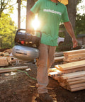 Person carrying The Tank Portable Pancake Air Compressor 200 PSI 6 Gallon Tank Built For Framing Siding Finish Brad tasks