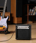 DEA 20W Electric Guitar Amp With Built In Reverb Clean And Overdrive Switch Treble And Bass EQ on wooden floor with guitar